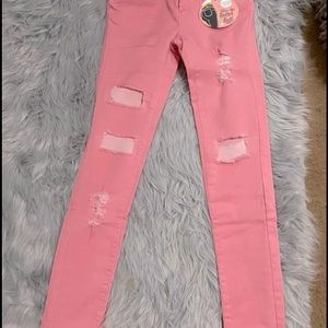 Pink distressed denim jeans